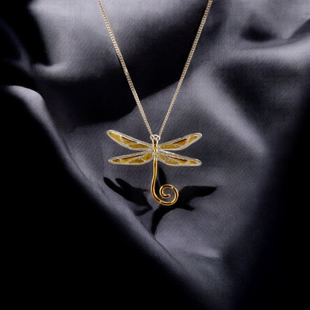 Gold dragonfly pendant with white-gold chain from RossJewelrys on dark silk background.

