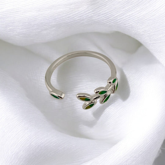 Silver ring with green enamel leaf accents shaped like a branch