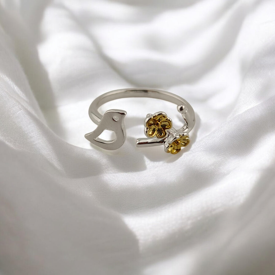 Rear view of open silver ring with curved adjustable band