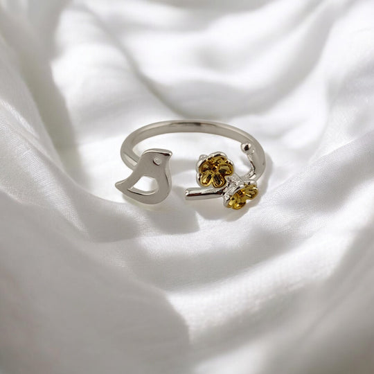 Rear view of open silver ring with curved adjustable band