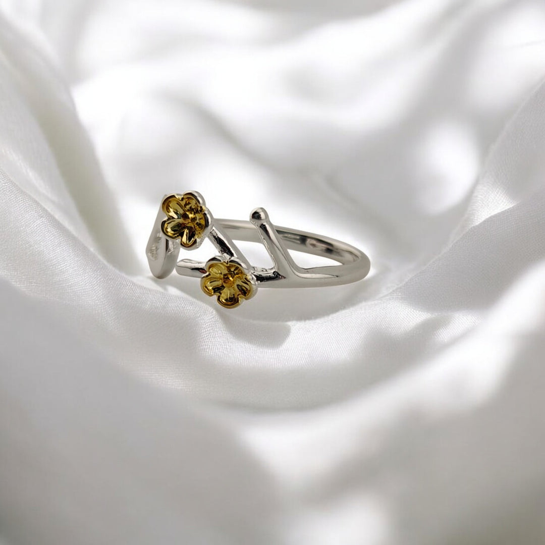 Close-up of bird and flowers on adjustable silver ring