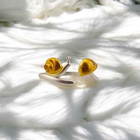 Frontal view of adjustable snail ring with detailed head and shell