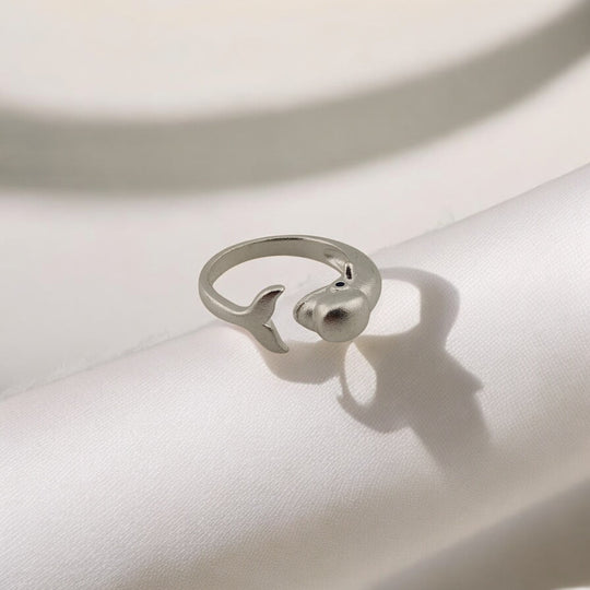 Dolphin ring curved into open loop with tail and head visible