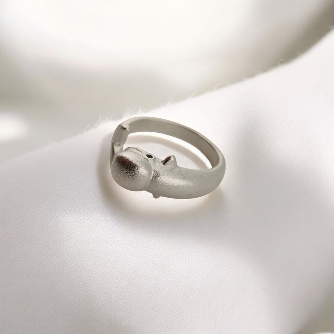 Close-up showing dolphin's head on silver ring from above