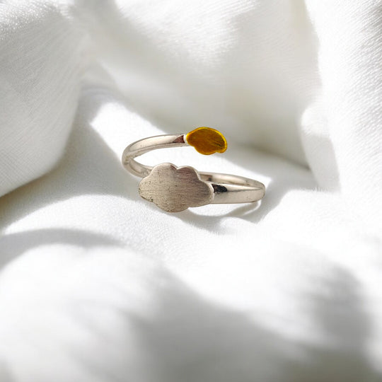Front angle of whimsical ring with yellow and silver weather theme