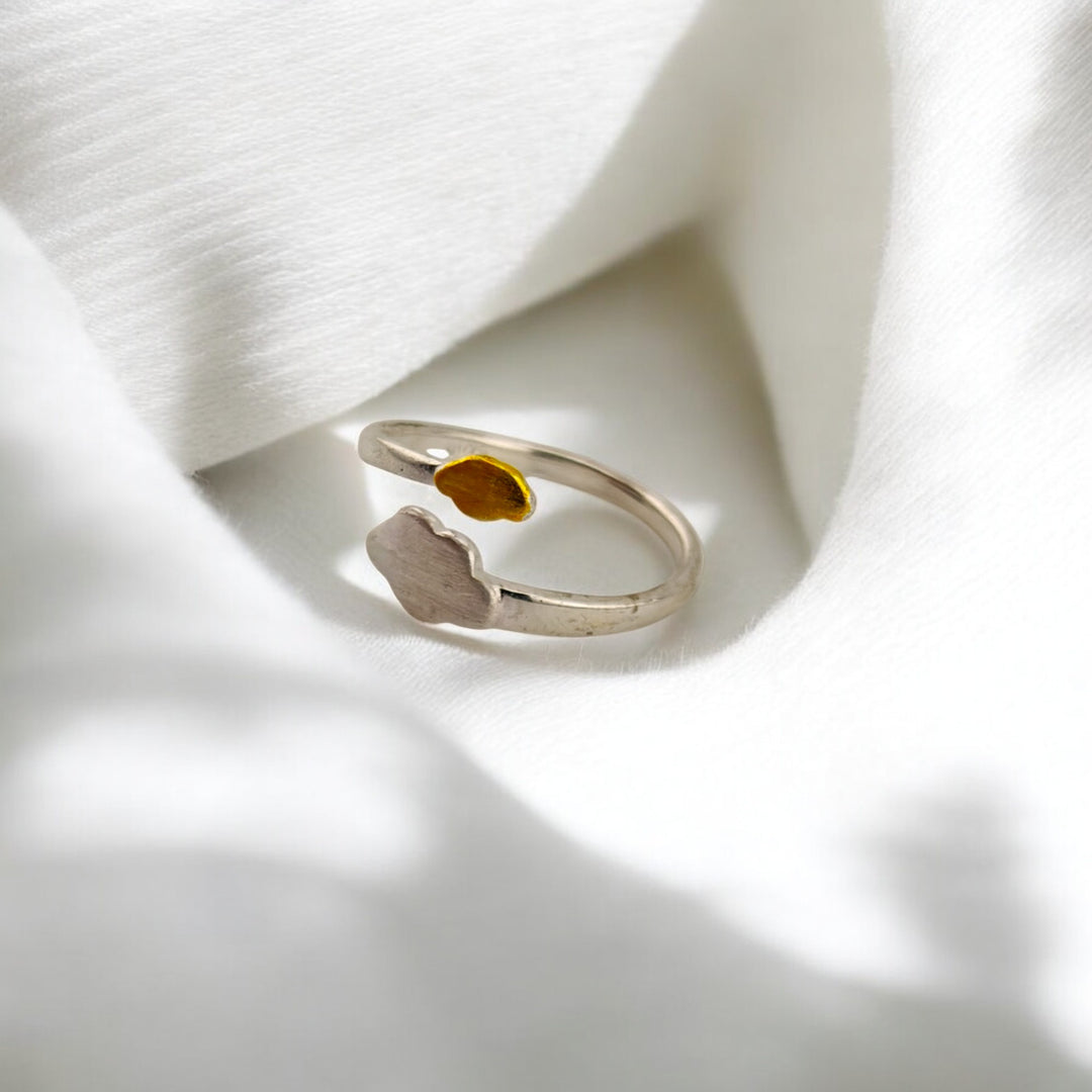 Side view of open silver ring showing matte cloud and enamel raindrop

