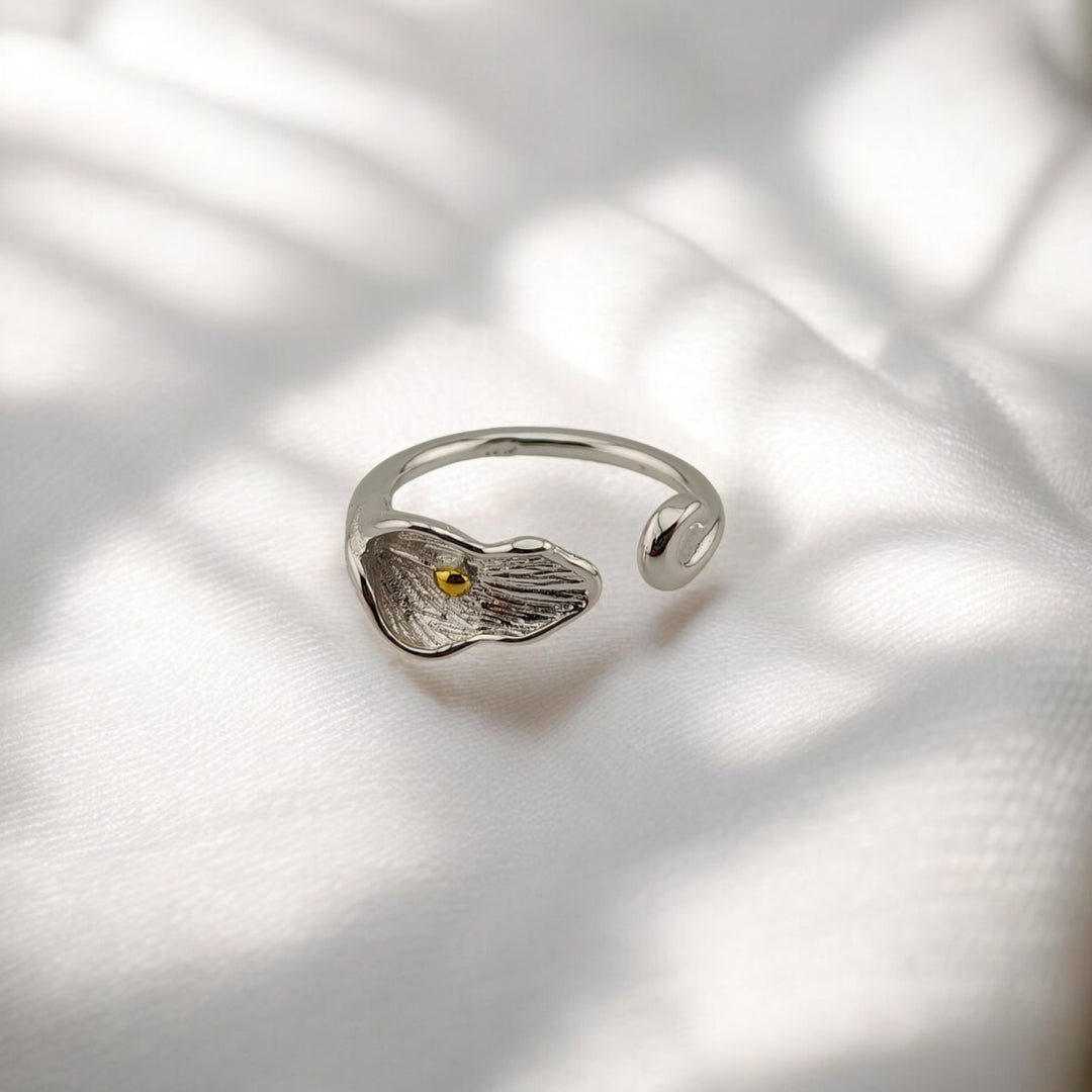 Front angle of calla lily-shaped adjustable silver ring with petal texture