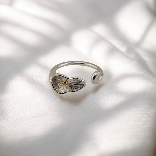 Front angle of calla lily-shaped adjustable silver ring with petal texture