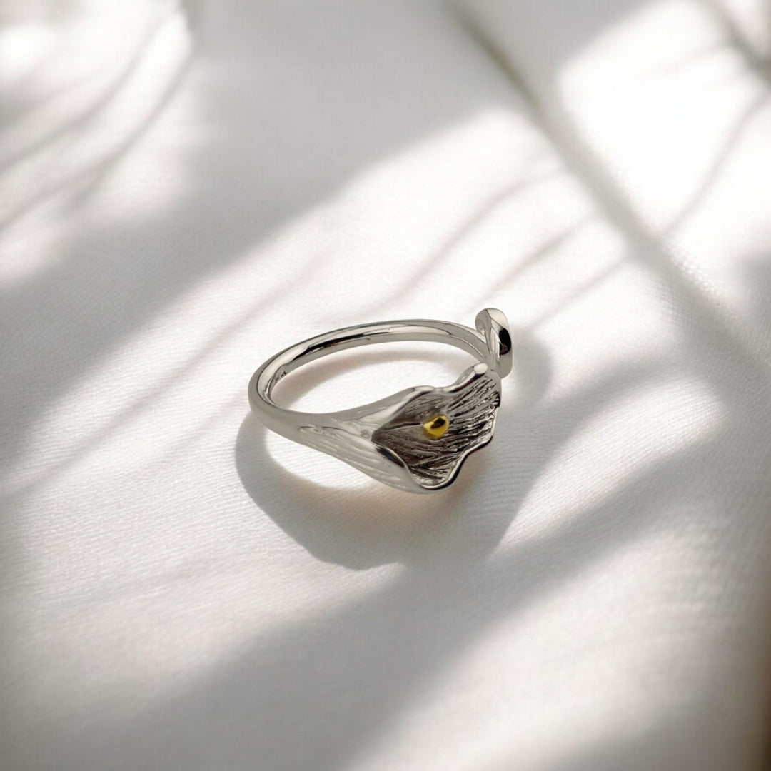 Side angle showing the curve and floral texture of silver calla ring