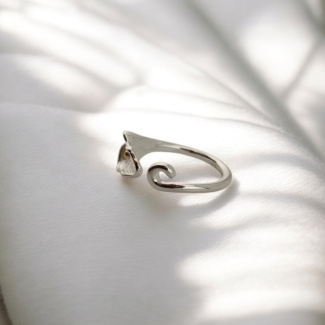 Back view of open silver ring with calla flower tip and curved end