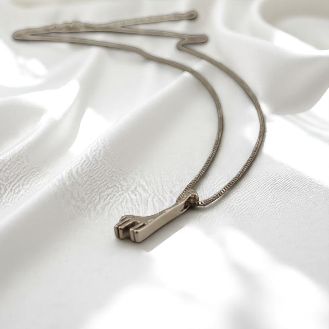 Close-up of giraffe charm necklace on silver chain