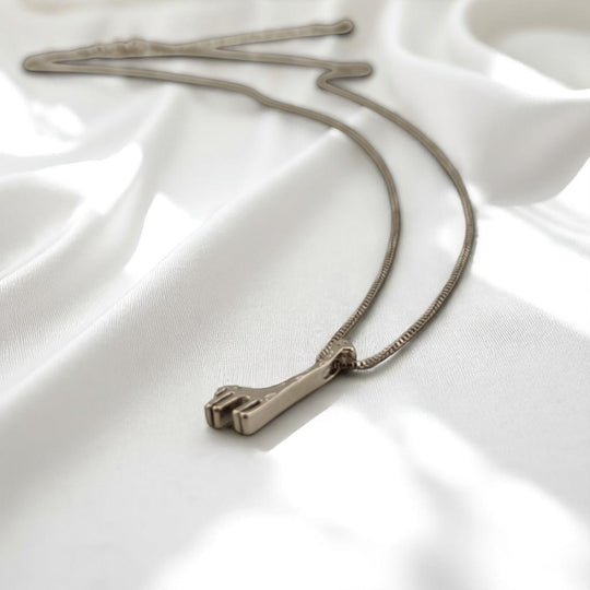 Close-up of giraffe charm necklace on silver chain