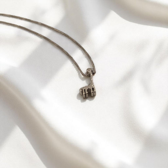 Animal-themed silver necklace with giraffe figure