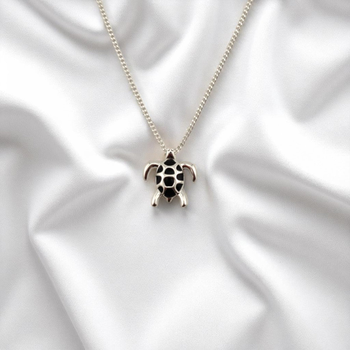 Silver-plated sea turtle necklace with black enamel shell