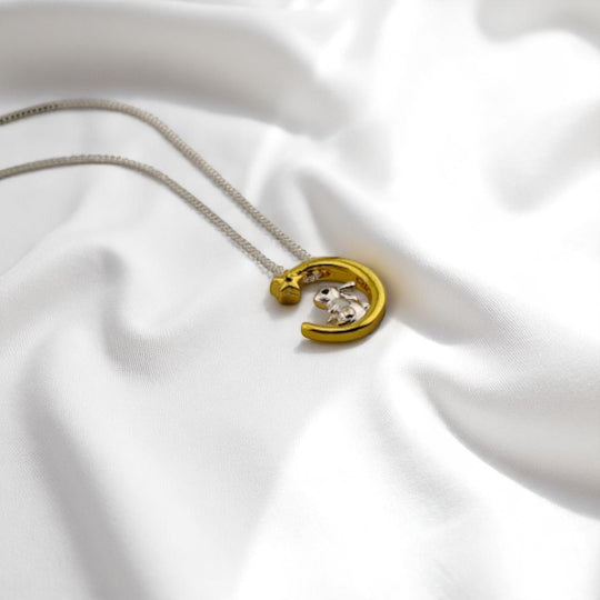 Close-up of silver bunny on gold crescent moon necklace – RossJewelrys