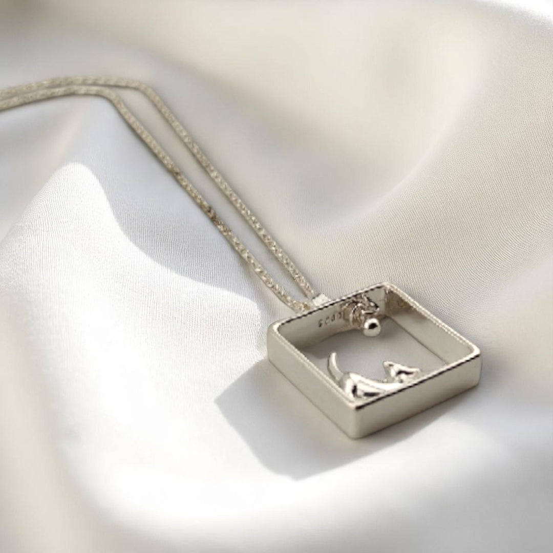 Minimalist square pendant with dog figure in silver finish