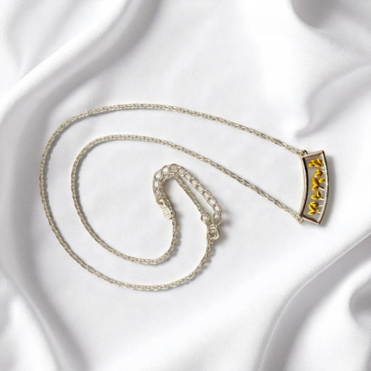 Eco-conscious necklace with sprouting yellow leaves in a curve