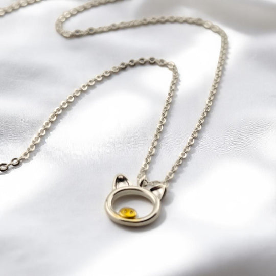 Close-up of pig charm pendant with visible yellow nose detail