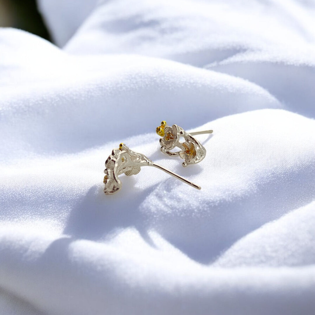 Side view of nature-inspired floral climber earrings with textured petals

