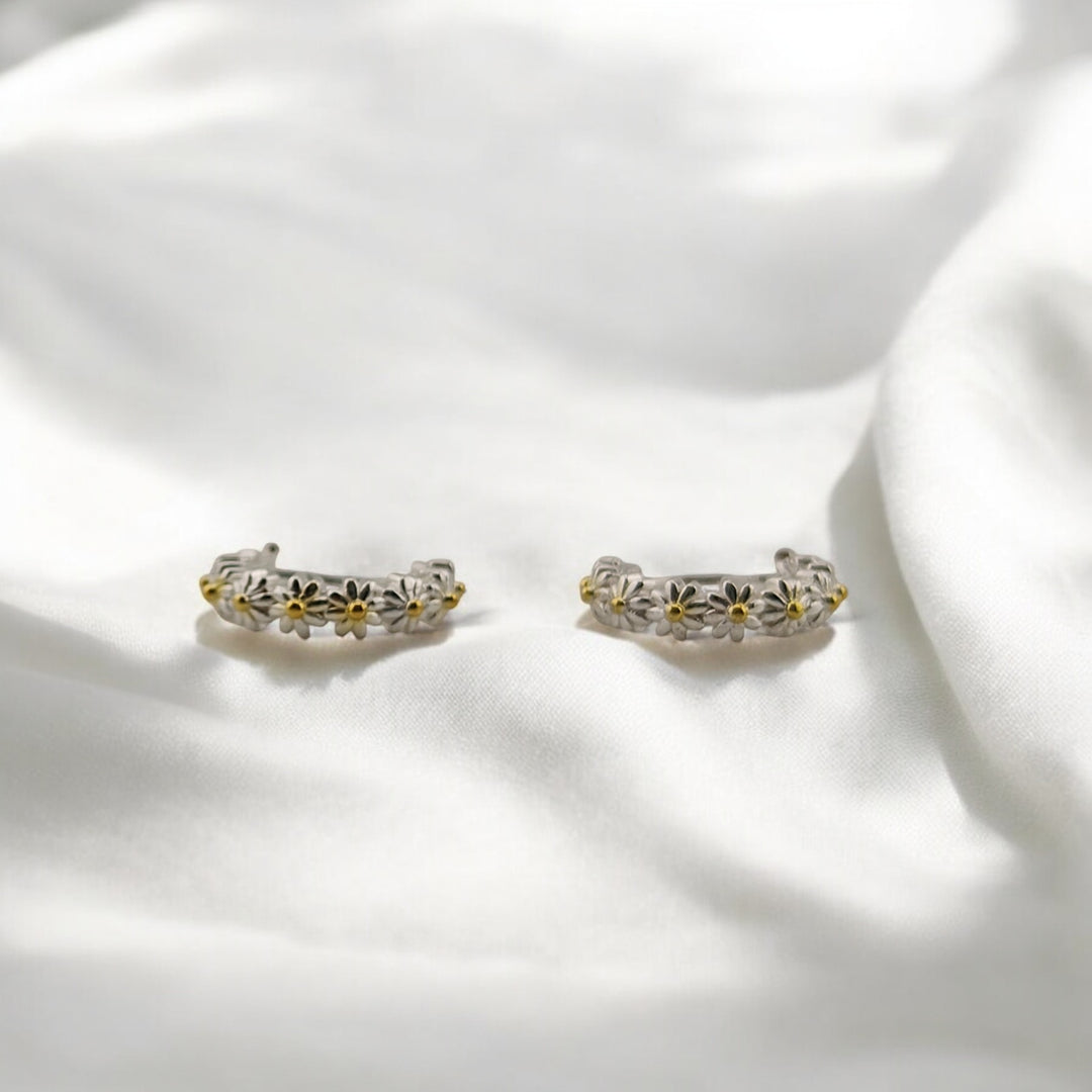 Eco-friendly floral hoop earrings with latch-back closure, displayed in sunlight