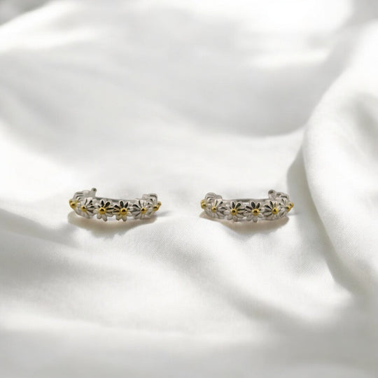 Eco-friendly floral hoop earrings with latch-back closure, displayed in sunlight