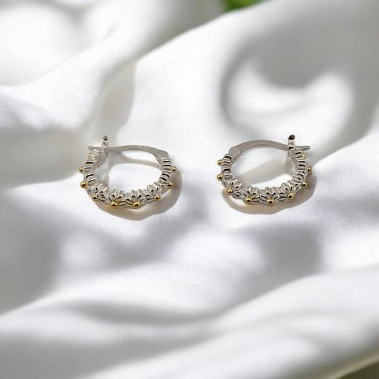 Floral hoop earrings with visible petal engravings and curved open view