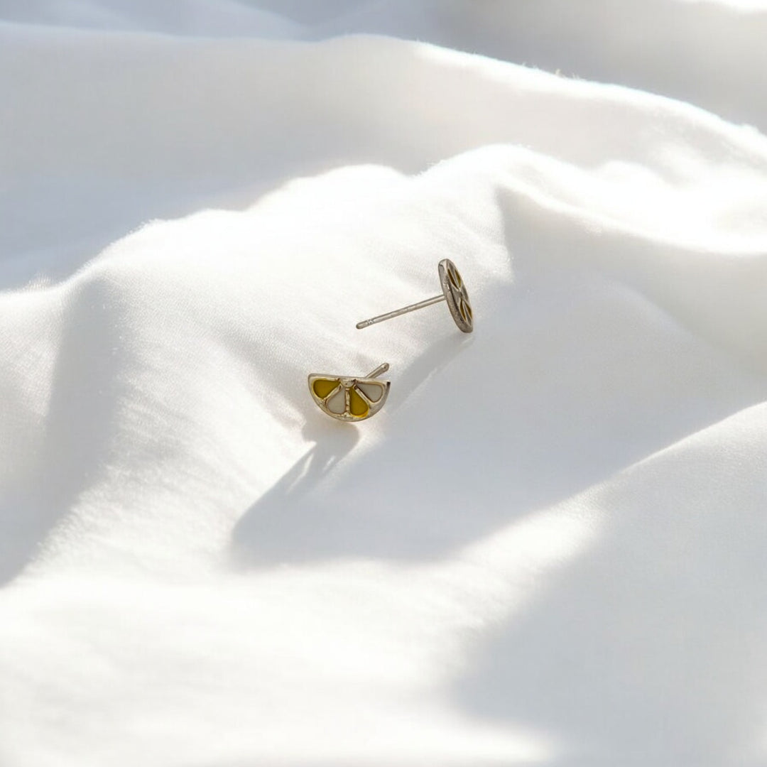 Back view of the mismatched lemon slice earrings showing their studs