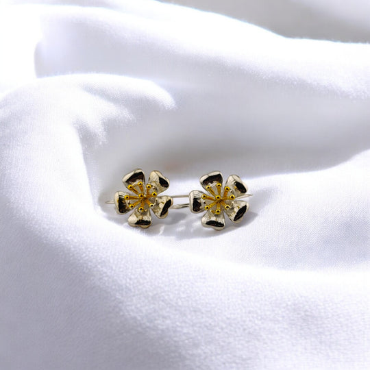 Pair of blooming flower earrings in silver and gold shown from front view