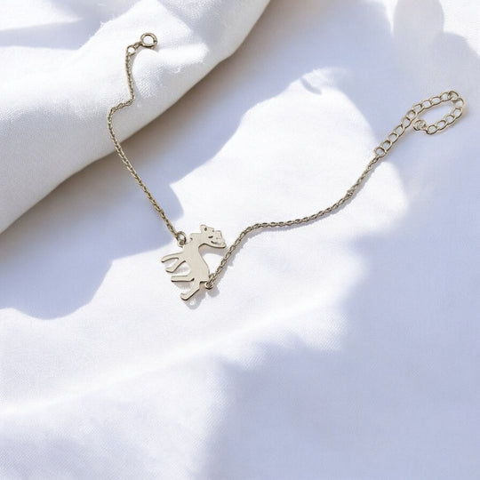 Zoomed-in angle of the reindeer charm on the bracelet from RossJewelrys, showing its fine brushed texture and chain clasp.


