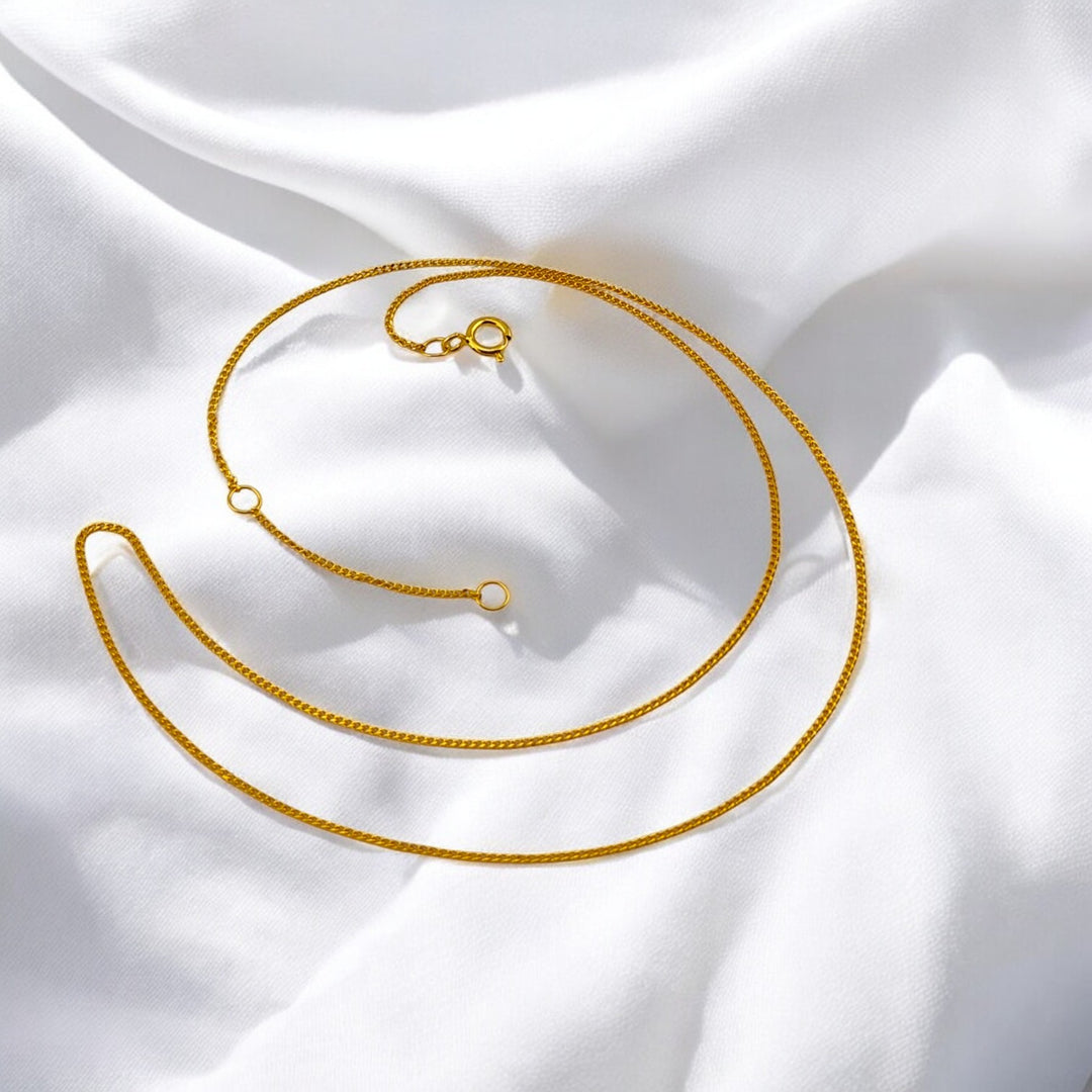 Adjustable 18k gold-plated sterling silver necklace with two closure rings, highlighted on white fabric – RossJewelrys minimalist chain.

