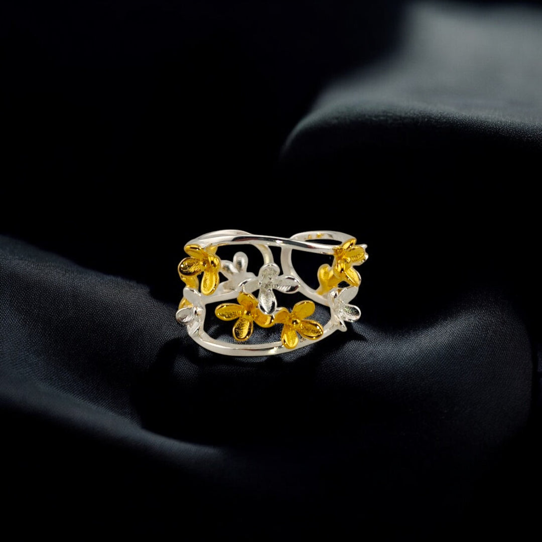 Silver and gold adjustable floral ring on black fabric background – RossJewelrys

