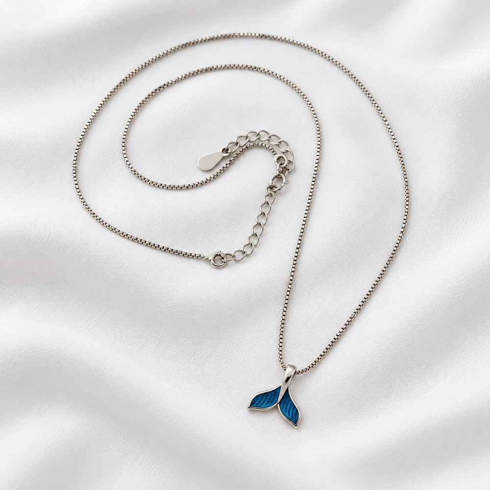 Dolphin tail necklace with a blue tail pendant, silver-tone chain and extension links