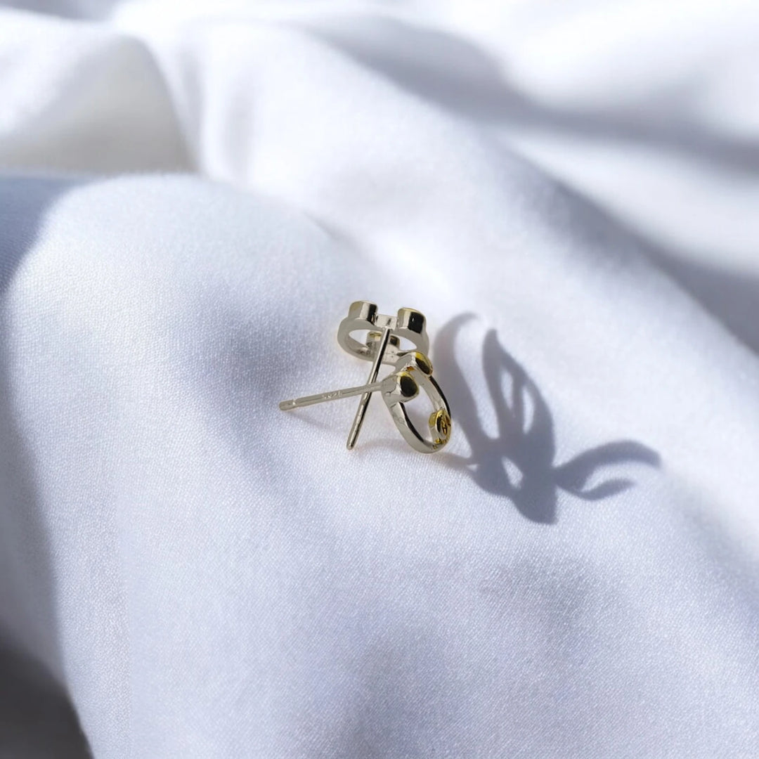 Rear view of pig stud earrings showing straight posts and butterfly backs