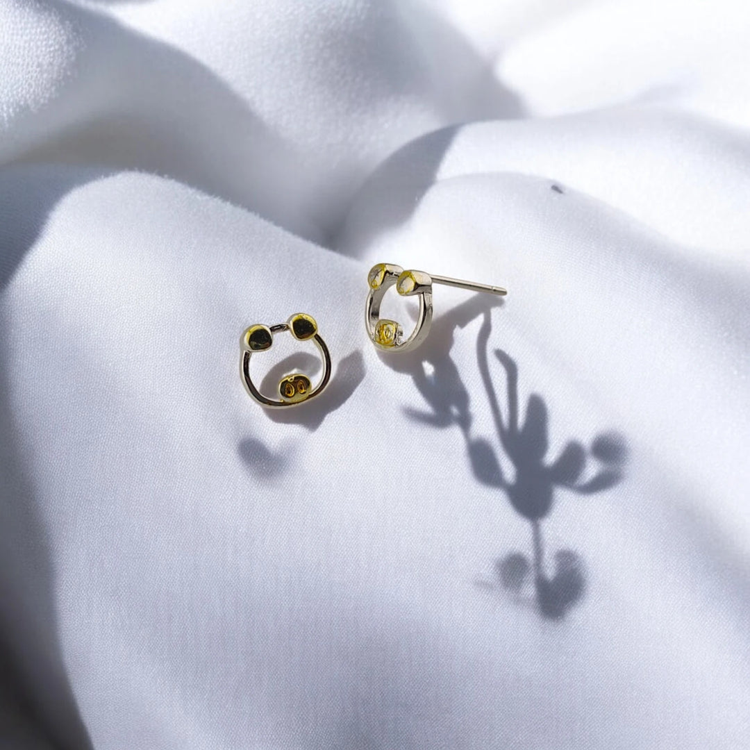 Side view of the pig stud earrings with two-tone face details and posts