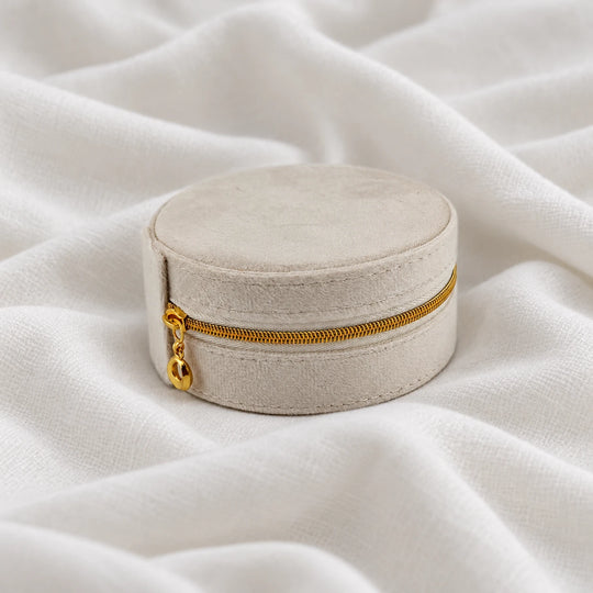 Closed cream velvet travel jewelry case with a gold-tone zipper