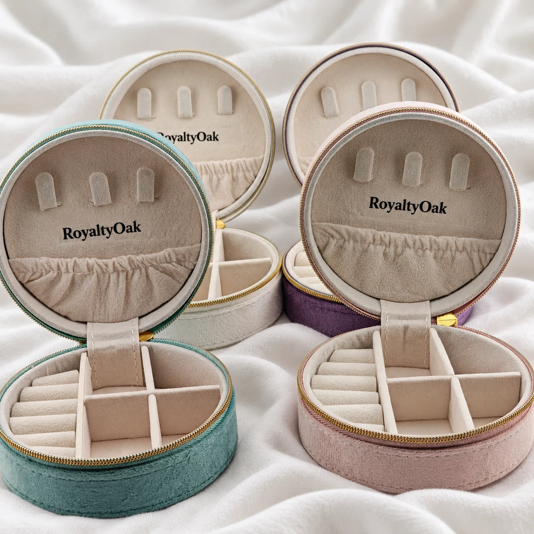 Four open velvet jewelry cases showing necklace hooks, ring rolls and divided compartments