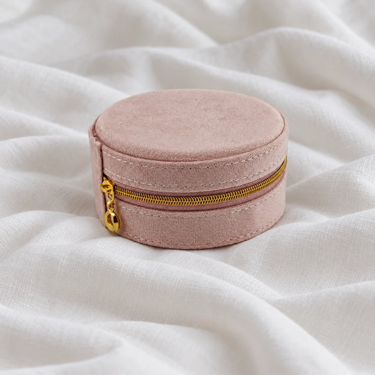 Closed pink velvet travel jewelry case with a gold-tone zipper