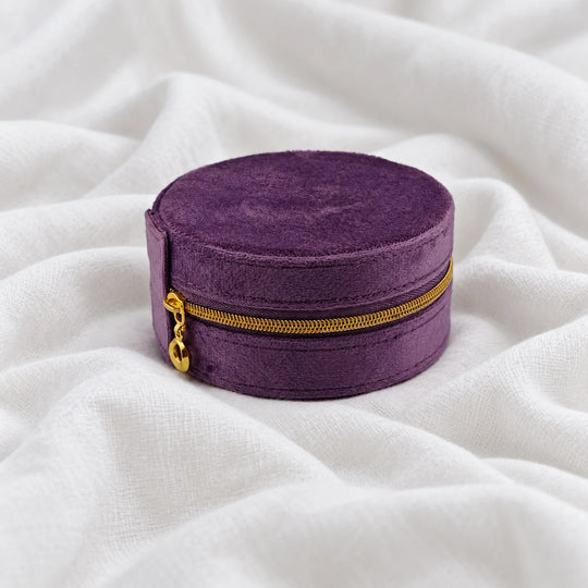 Closed purple velvet travel jewelry case with a gold-tone zipper