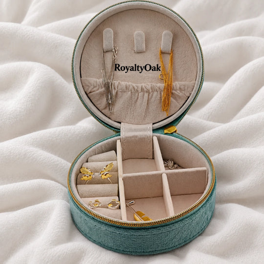 Angled view of a teal velvet jewelry case with jewelry arranged inside
