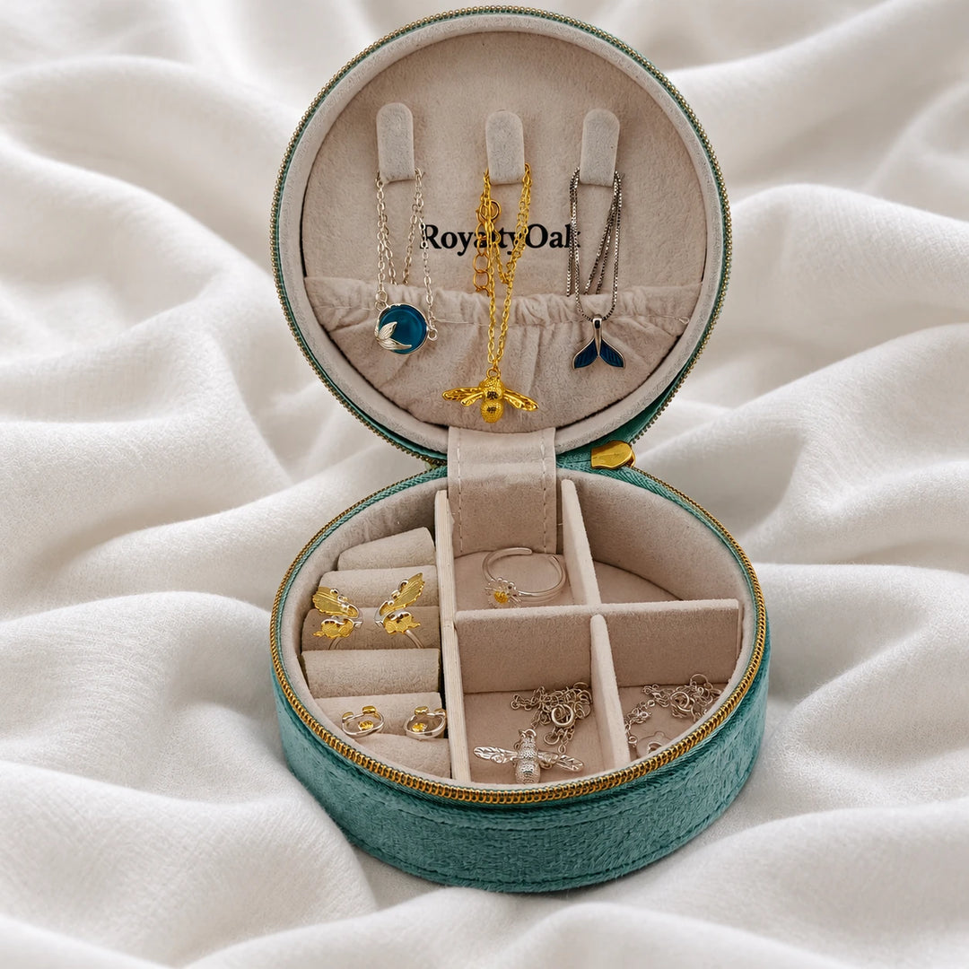 Open teal jewelry case holding necklaces, earrings and a ring in separate compartments